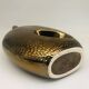 Golden ceramic vase.