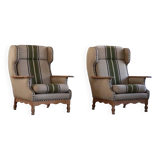 Pair of high-back lounge chairs in modern Danish style in the manner of Henning Kjærnulf, 1960s.