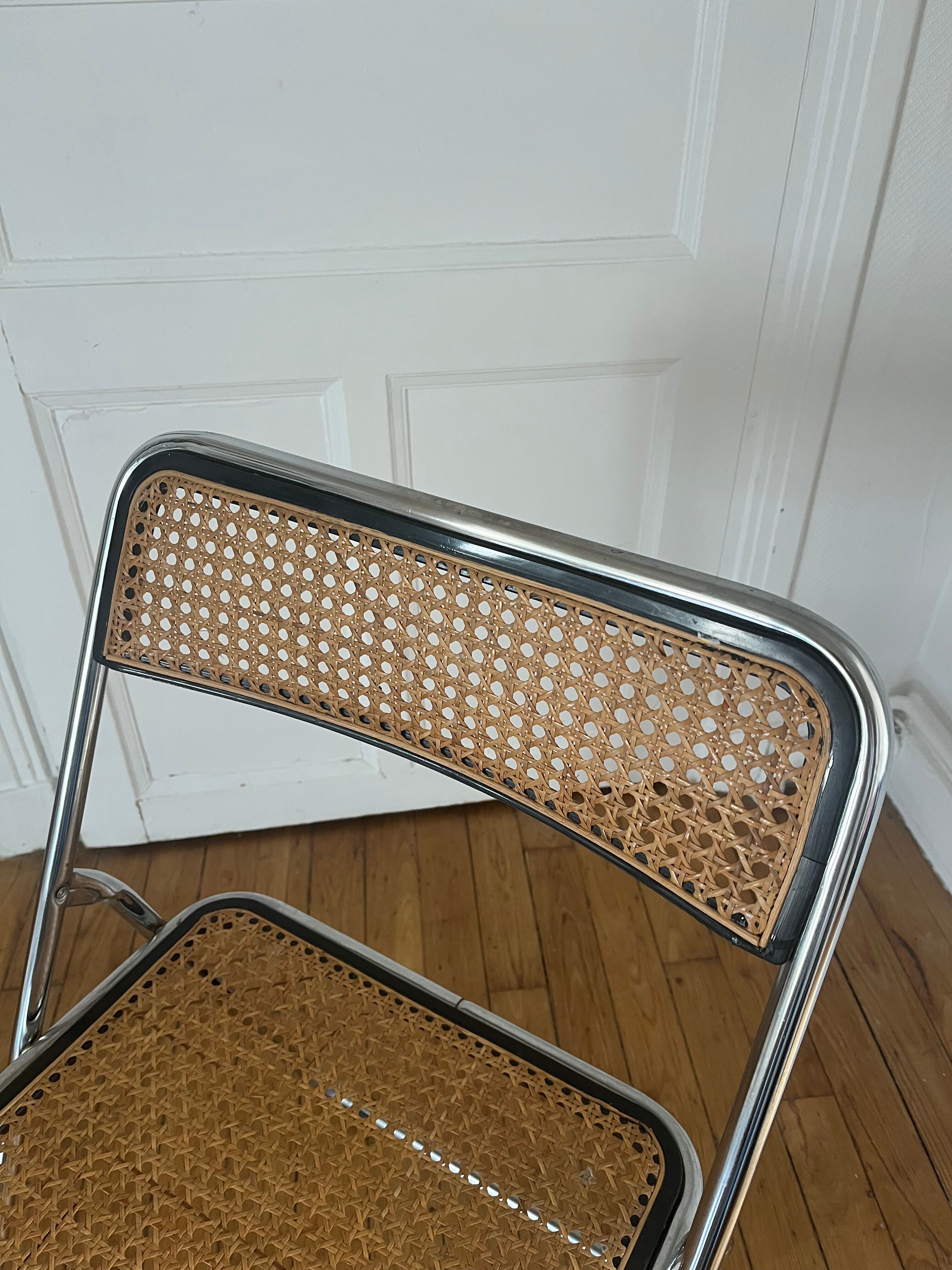 Vintage folding chair in metal and cane.