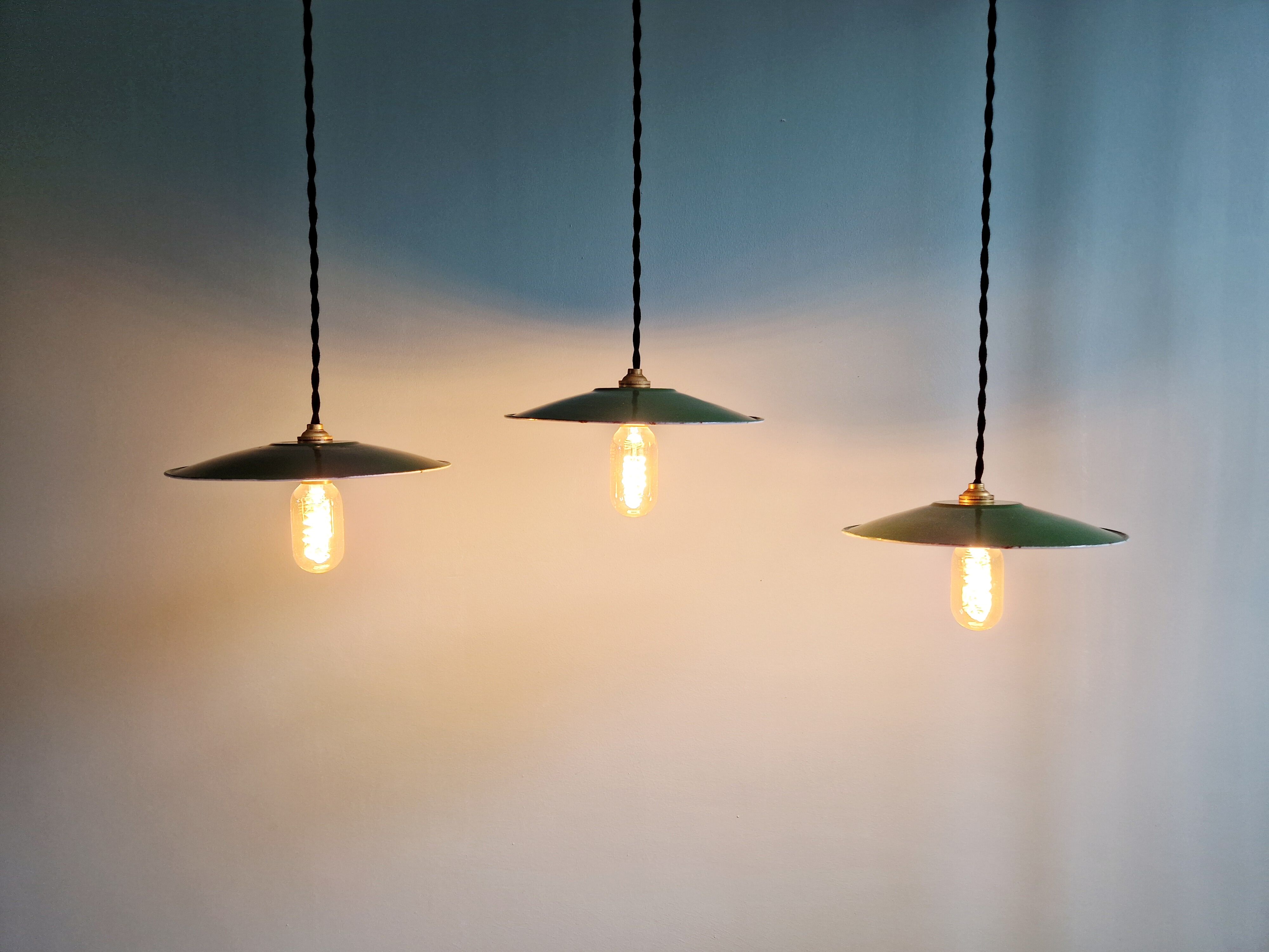 Trio of large industrial suspensions in green enamelled sheet metal.