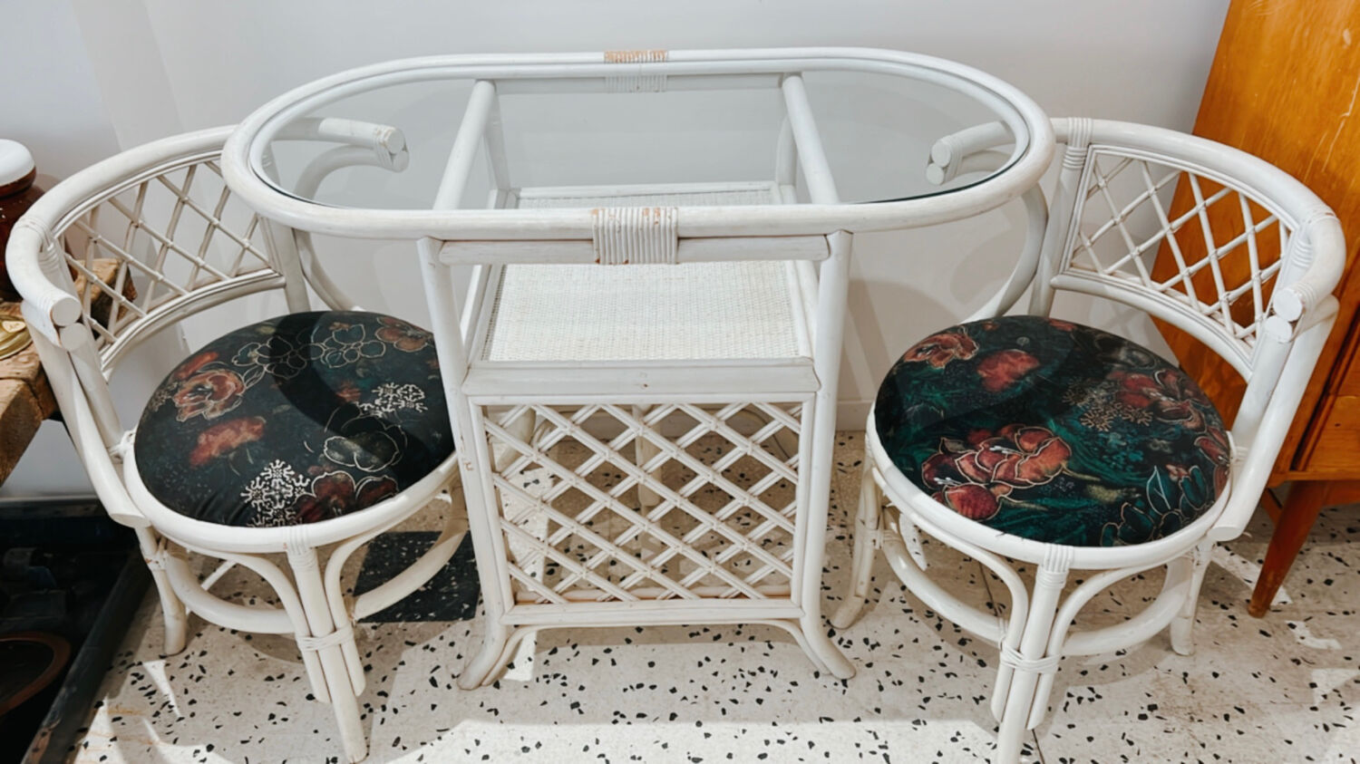 Rattan head-to-head table with vintage armchairs