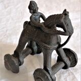 Old child's toy. Horse with bronze wheels. Ethnic object.