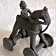 Old child's toy. Horse with bronze wheels. Ethnic object.