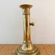 Old brass candlestick with push button.