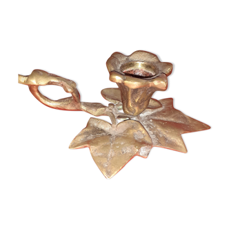 Old bronze candlestick in leaf shape.