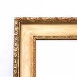 Horizontal mirror in a gold frame.