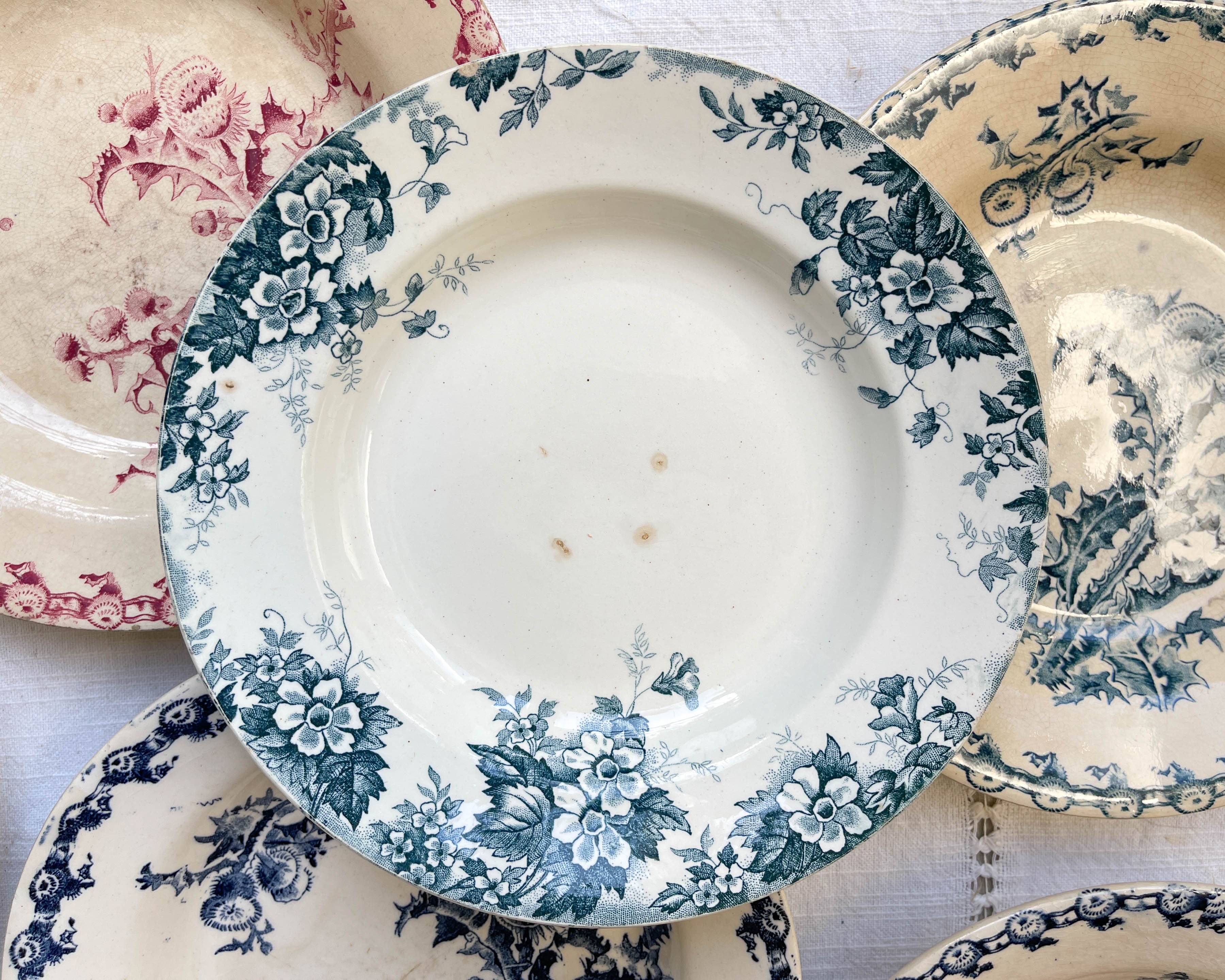 10 mismatched vintage soup plates in blue, green, and red ironstone