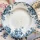 10 mismatched vintage soup plates in blue, green, and red ironstone