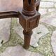 Old wooden pedestal table with marble top