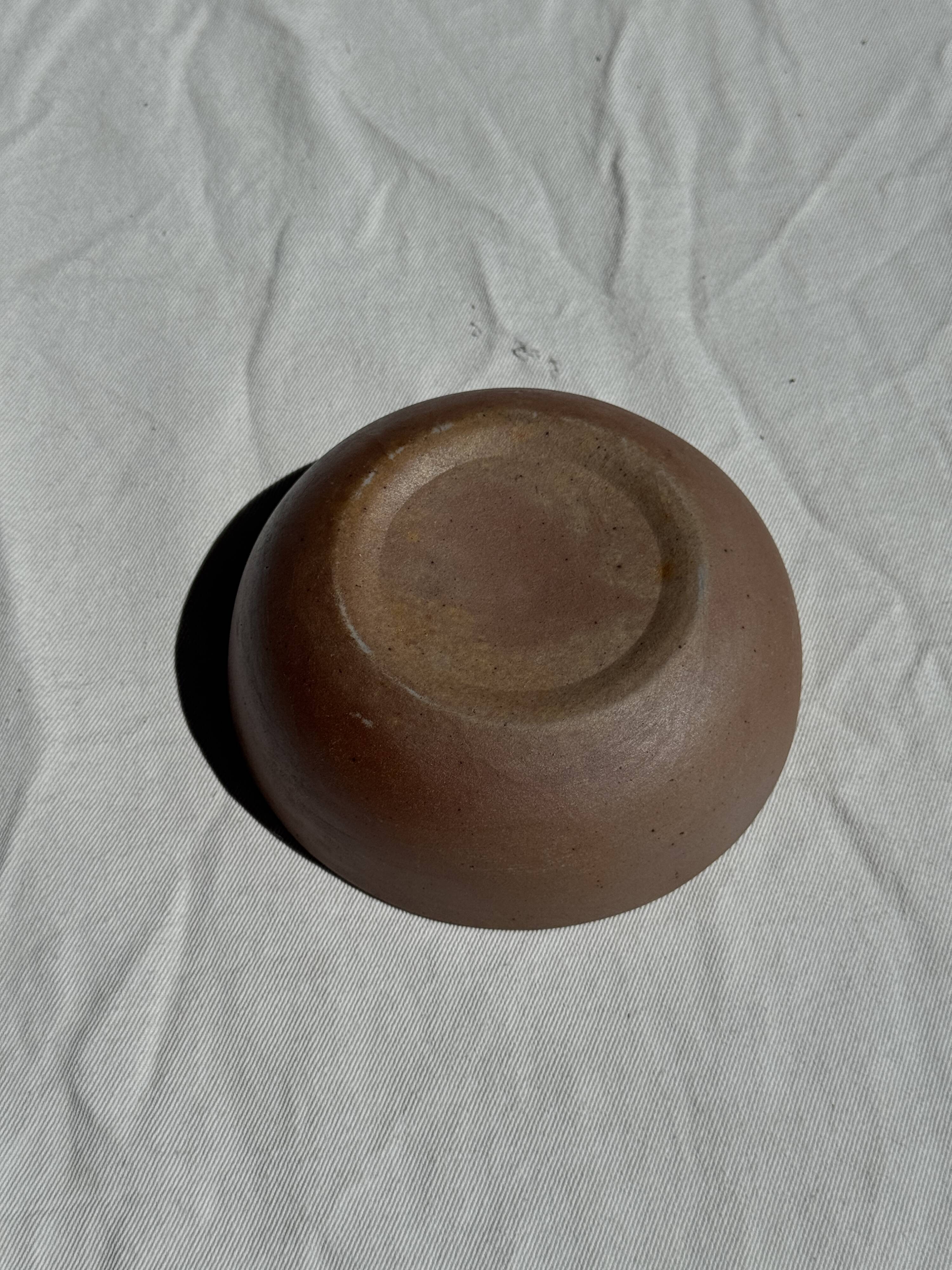 A speckled grey interior bowl with a matte brown exterior H5 D15