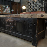 Former 1930 carpenter's workbench has black patinated doors and drawers