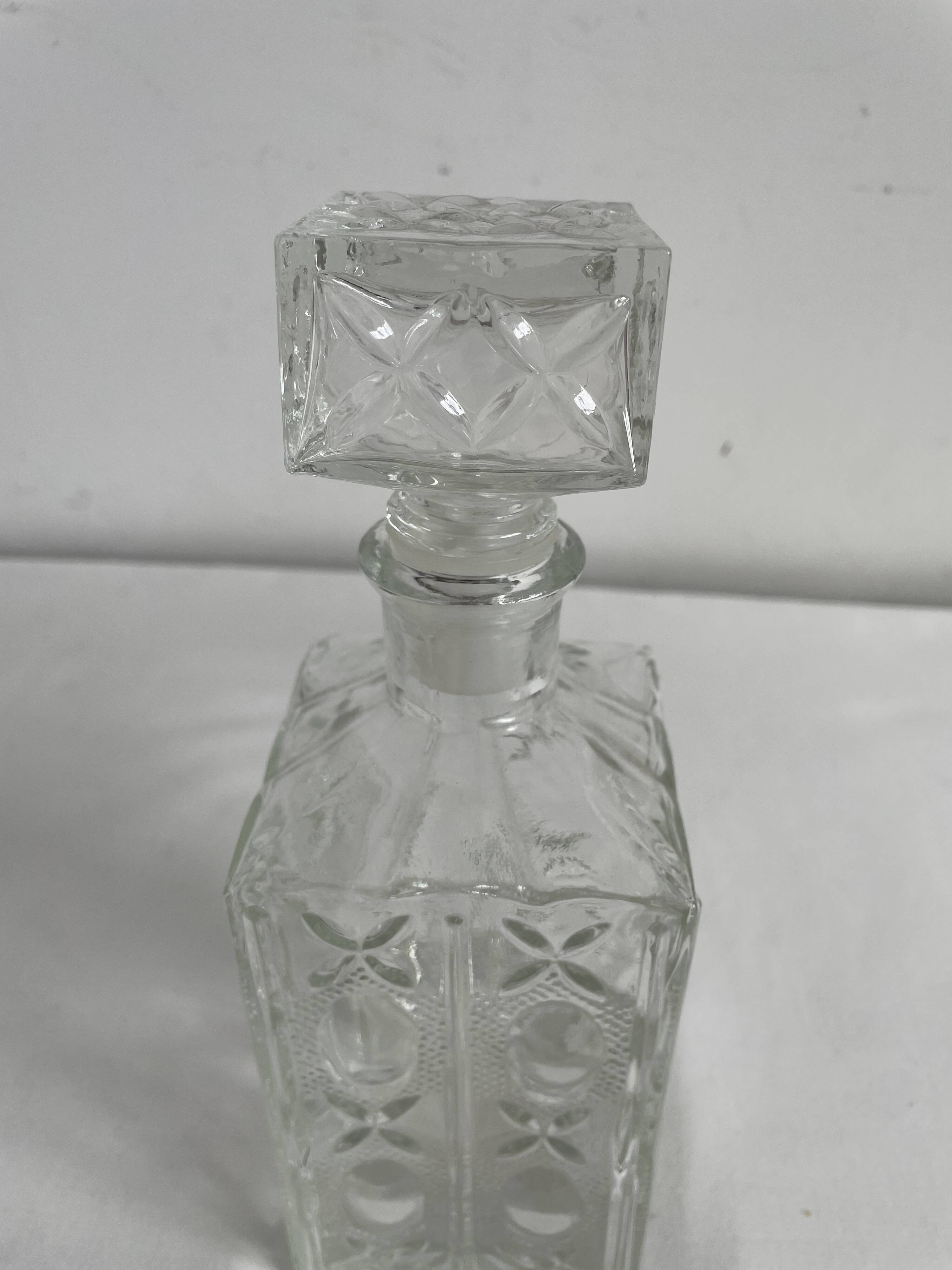 Molded glass carafe, 1960s-1970s, stylized flower decoration, oval, square base, stopper, rosette