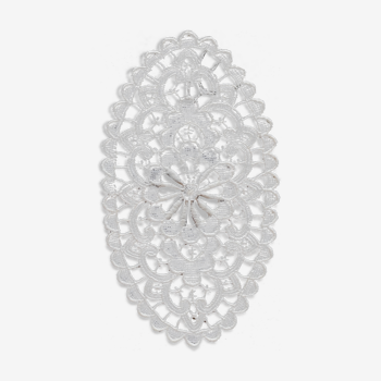 Old cotton crochet doily in the shape of a vintage embroidered warhead