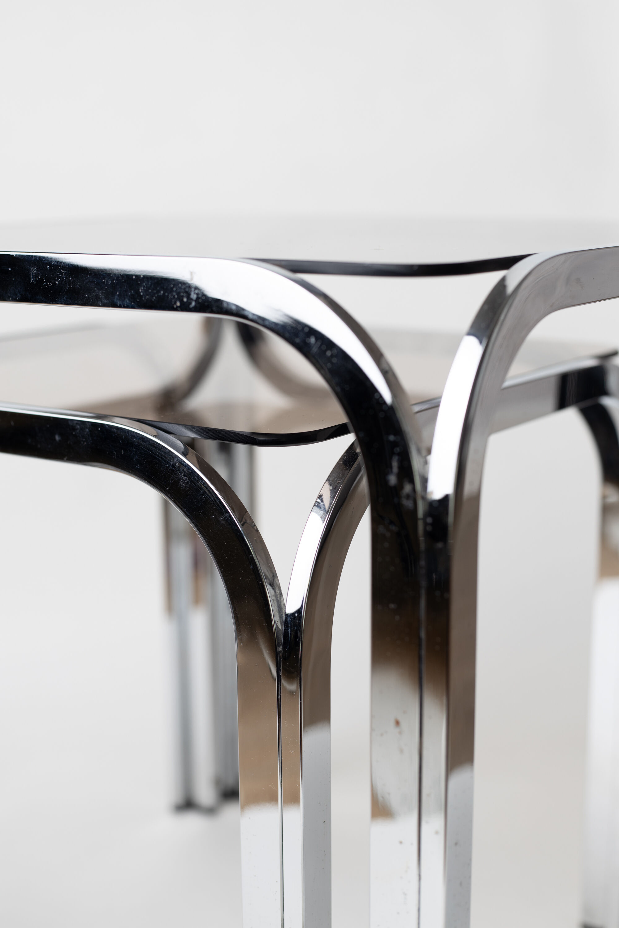 Pair of chrome nesting tables with smoked glass tops