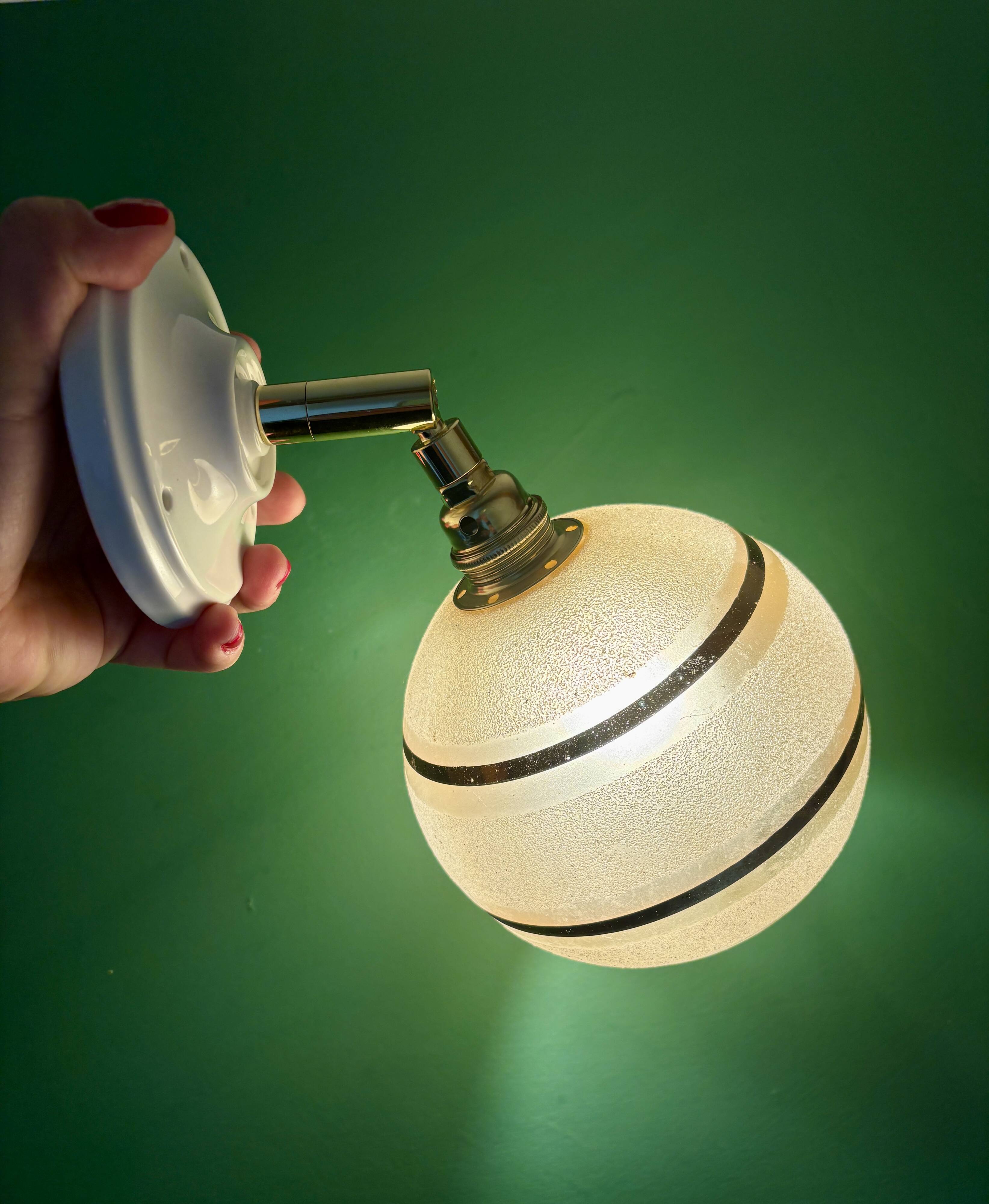 Vintage globe wall light in frosted yellow and gold glass.