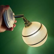 Vintage globe wall light in frosted yellow and gold glass.