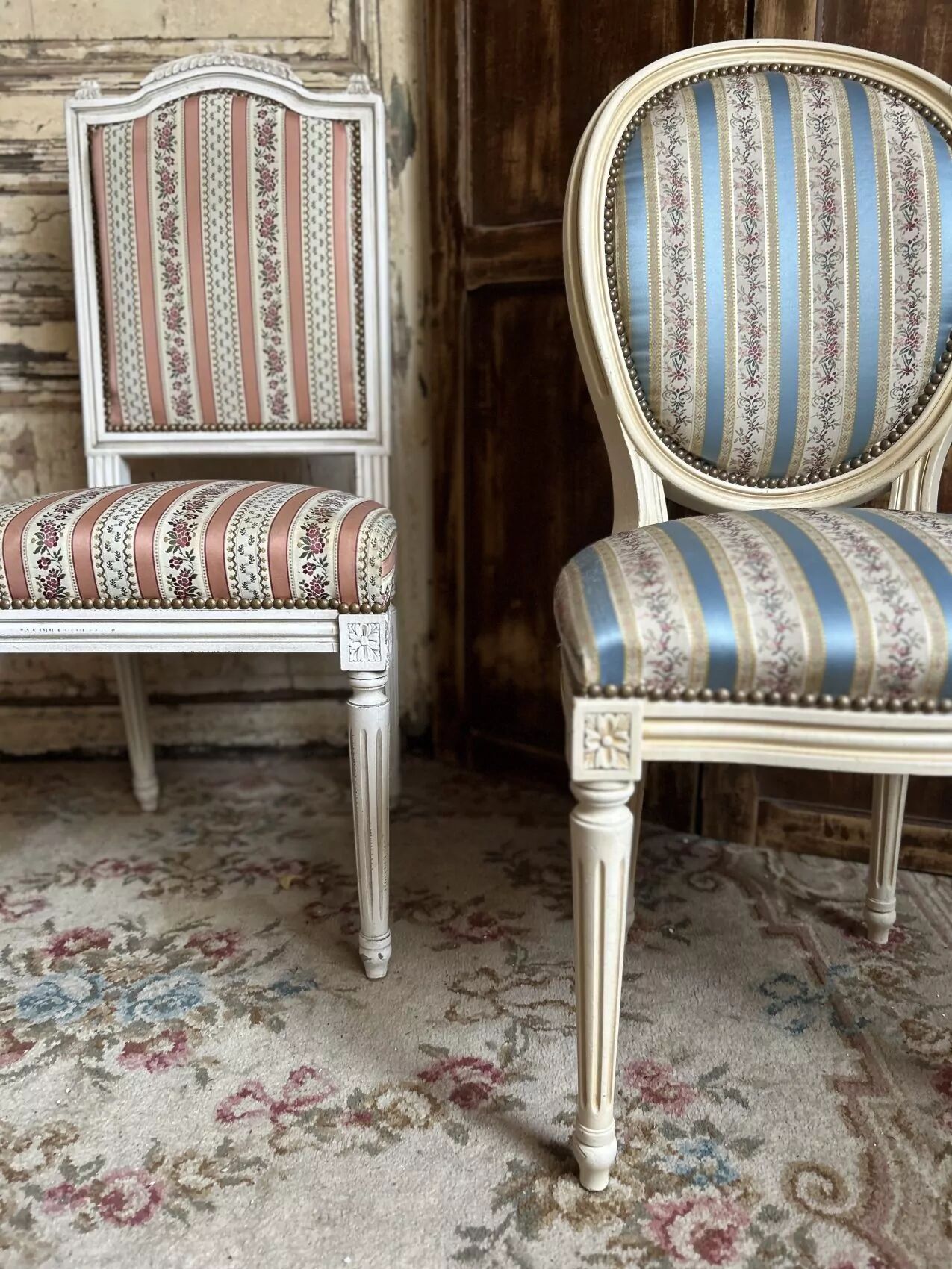 Pair of Louis XVI style chairs in painted wood and satin, classic elegance.