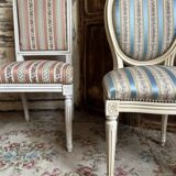 Pair of Louis XVI style chairs in painted wood and satin, classic elegance.