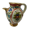 Vintage pitcher with floral decoration