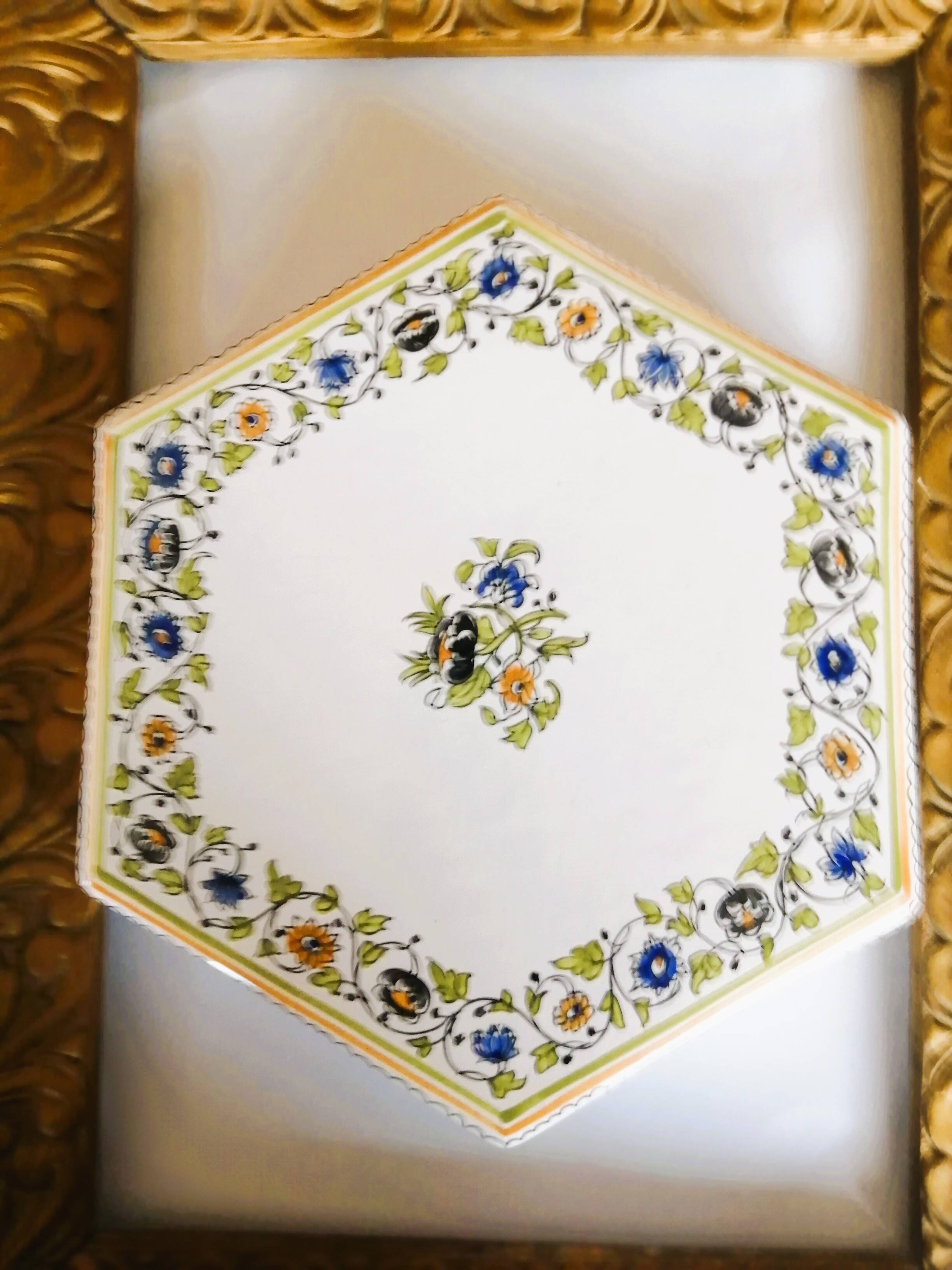 Hand-painted flat dish decorated in the Moustier style.