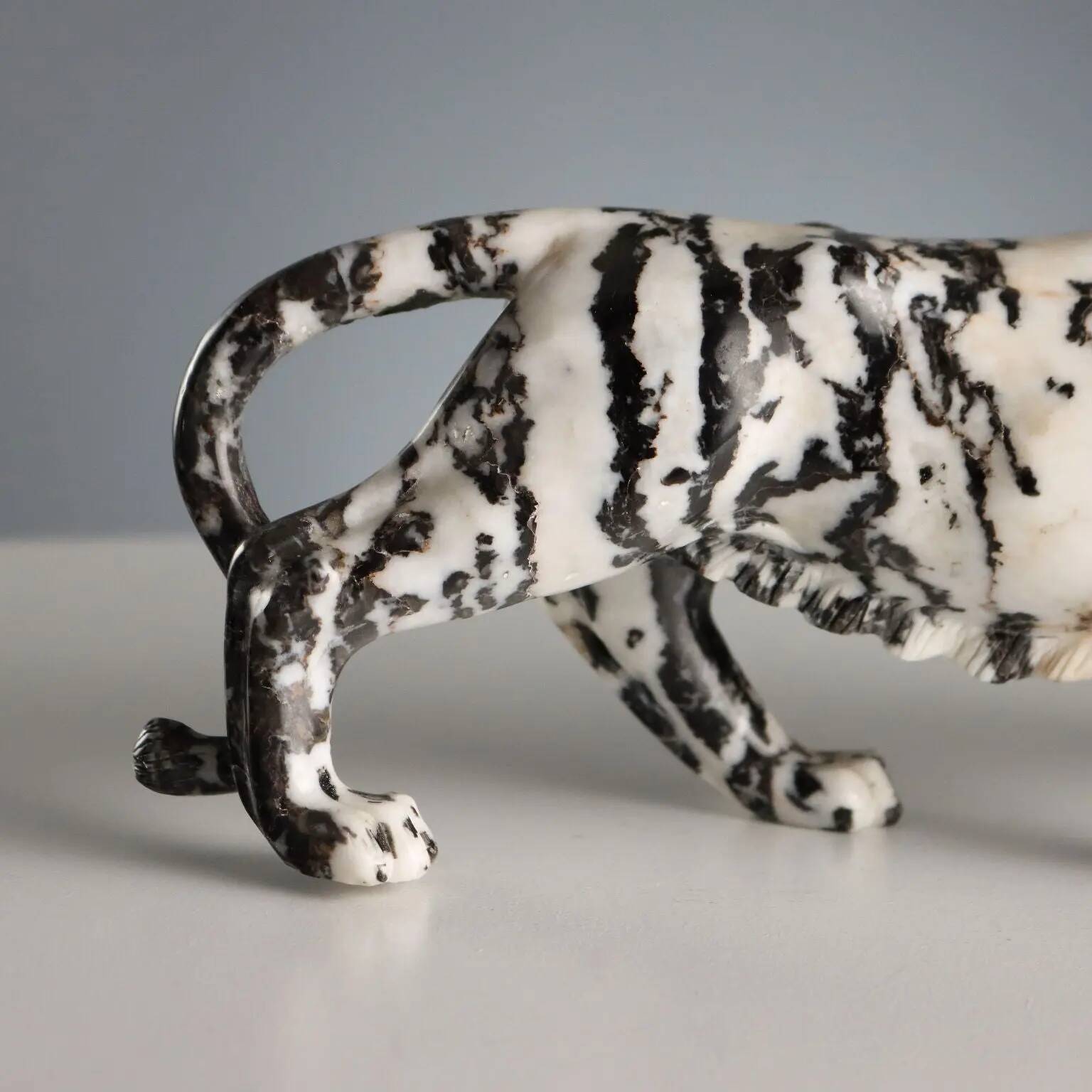 Ancient sculpture of a black and white marble panther, 20th century.