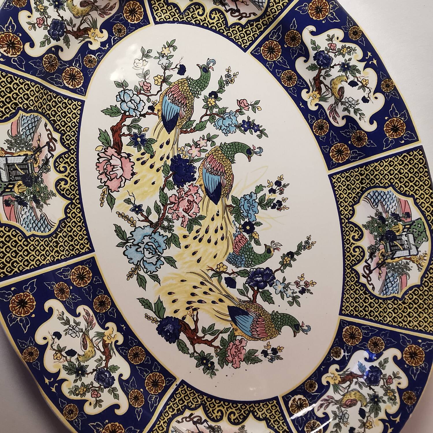 Ceramic dish decorated with peacock folk art Asian motif