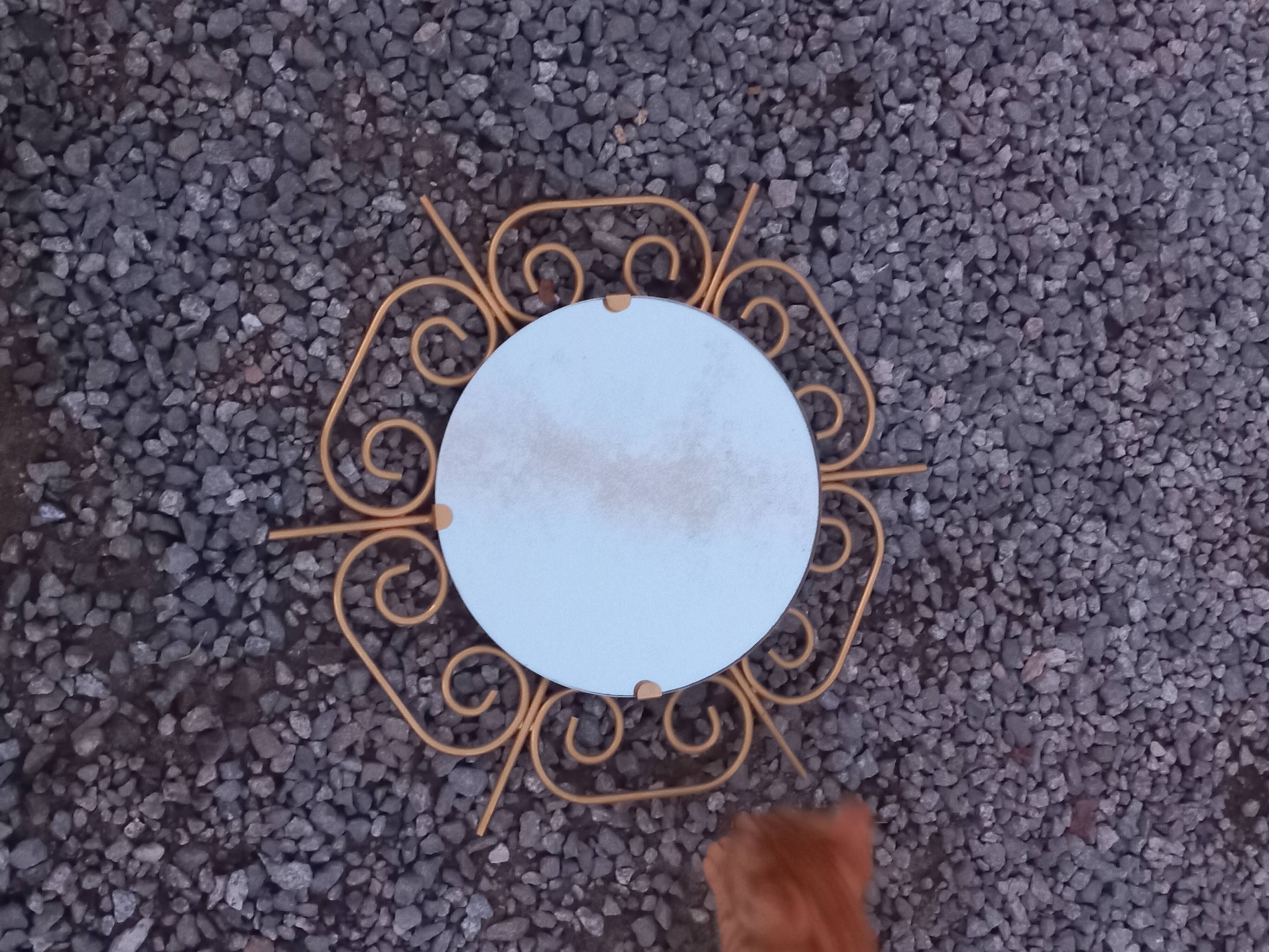 Golden metal sun mirror from the 1950s.