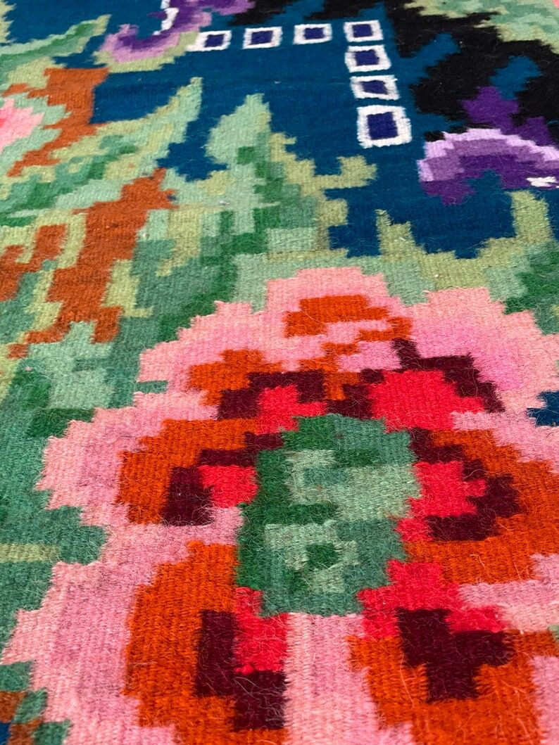 Rug with floral design on a blue background made by hand in Romania