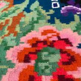 Rug with floral design on a blue background made by hand in Romania