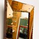 Striking French amber-coloured mirror with sculpted edge details, 1940s