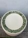 Set of 10 ceramic plates with green foliage decoration.
