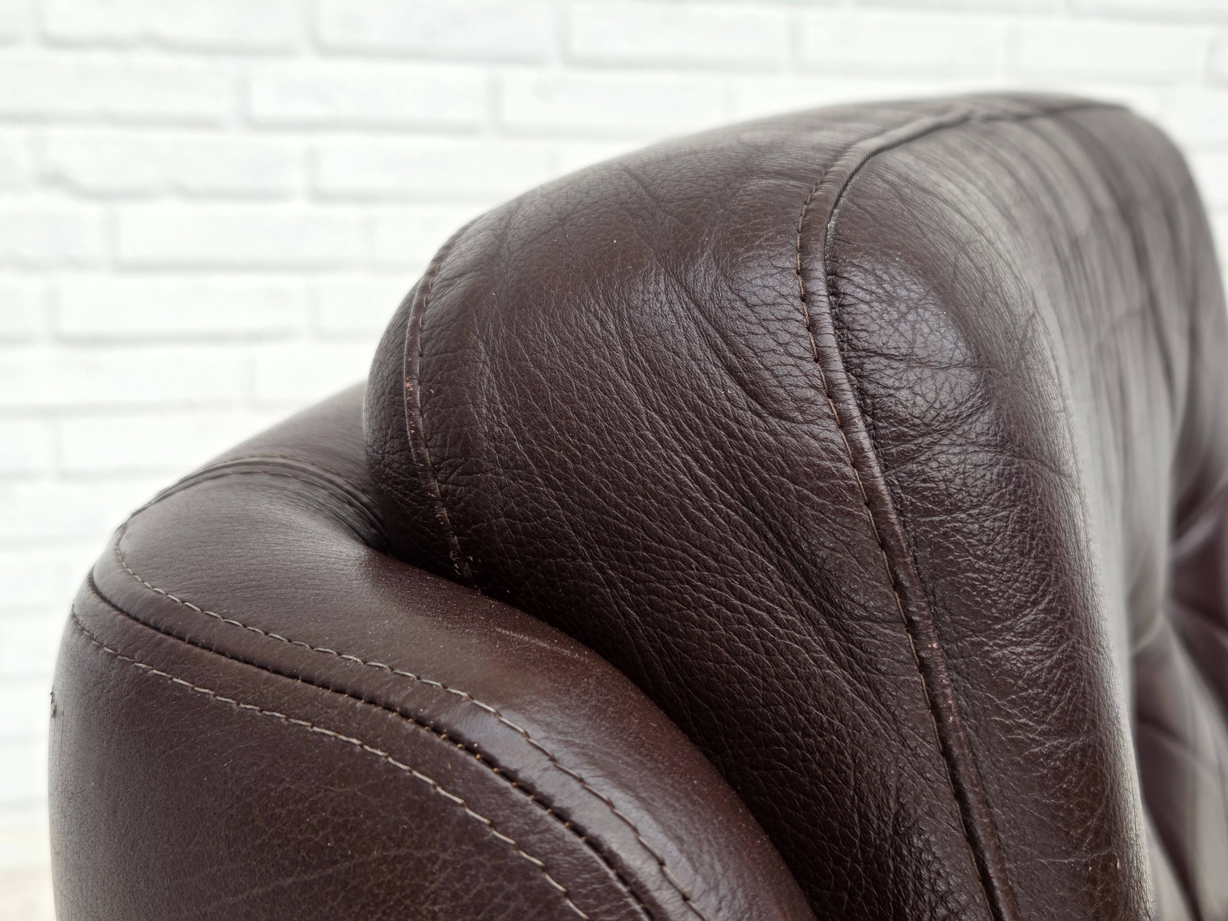 1970s, set of two swivel lounge chairs with footstool, leather.