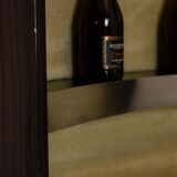 Circular bar in brushed metal, wood and carpet. 1970s.