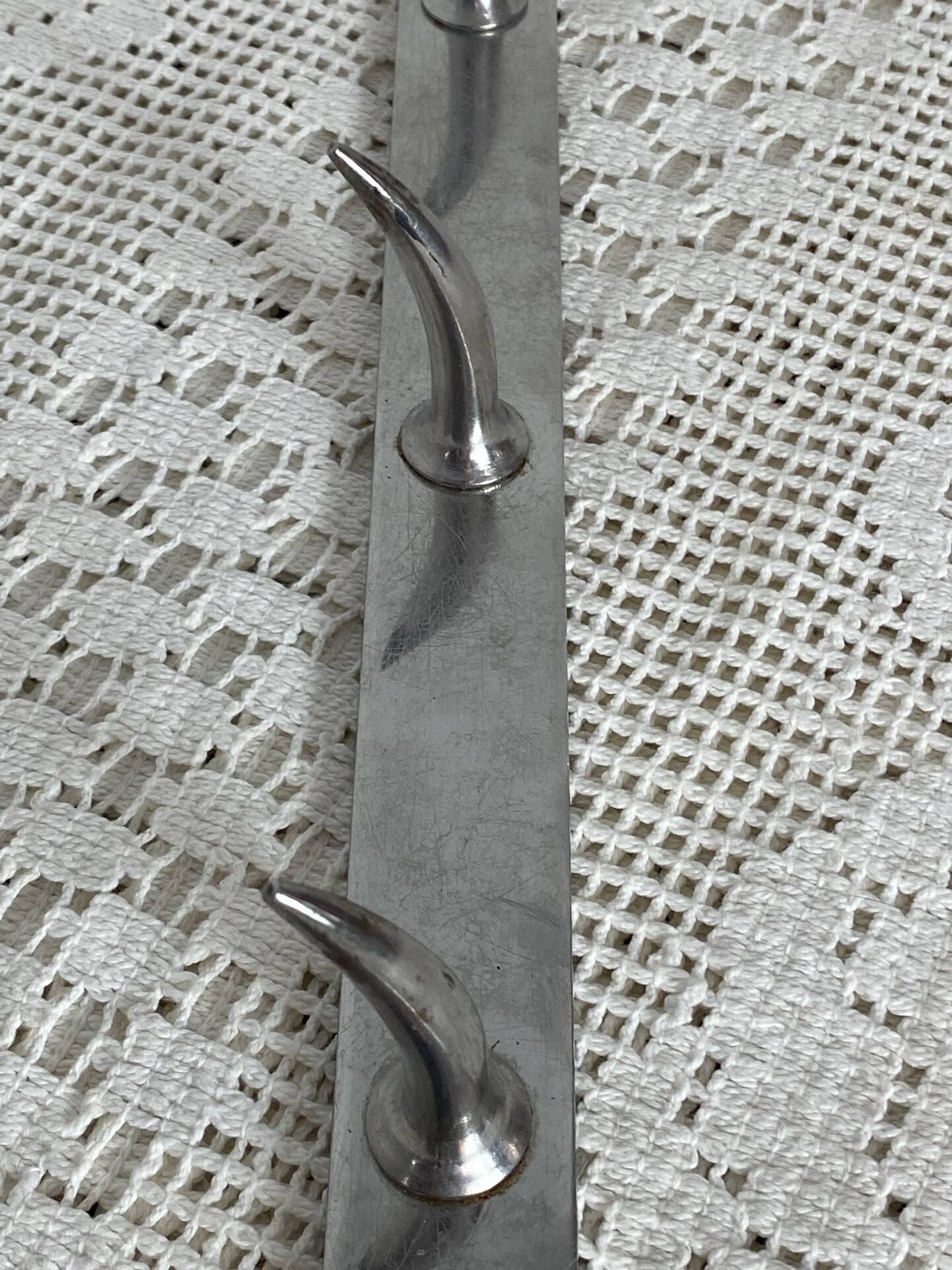 Stainless steel butcher's hook, known as a "wolf tooth bar."