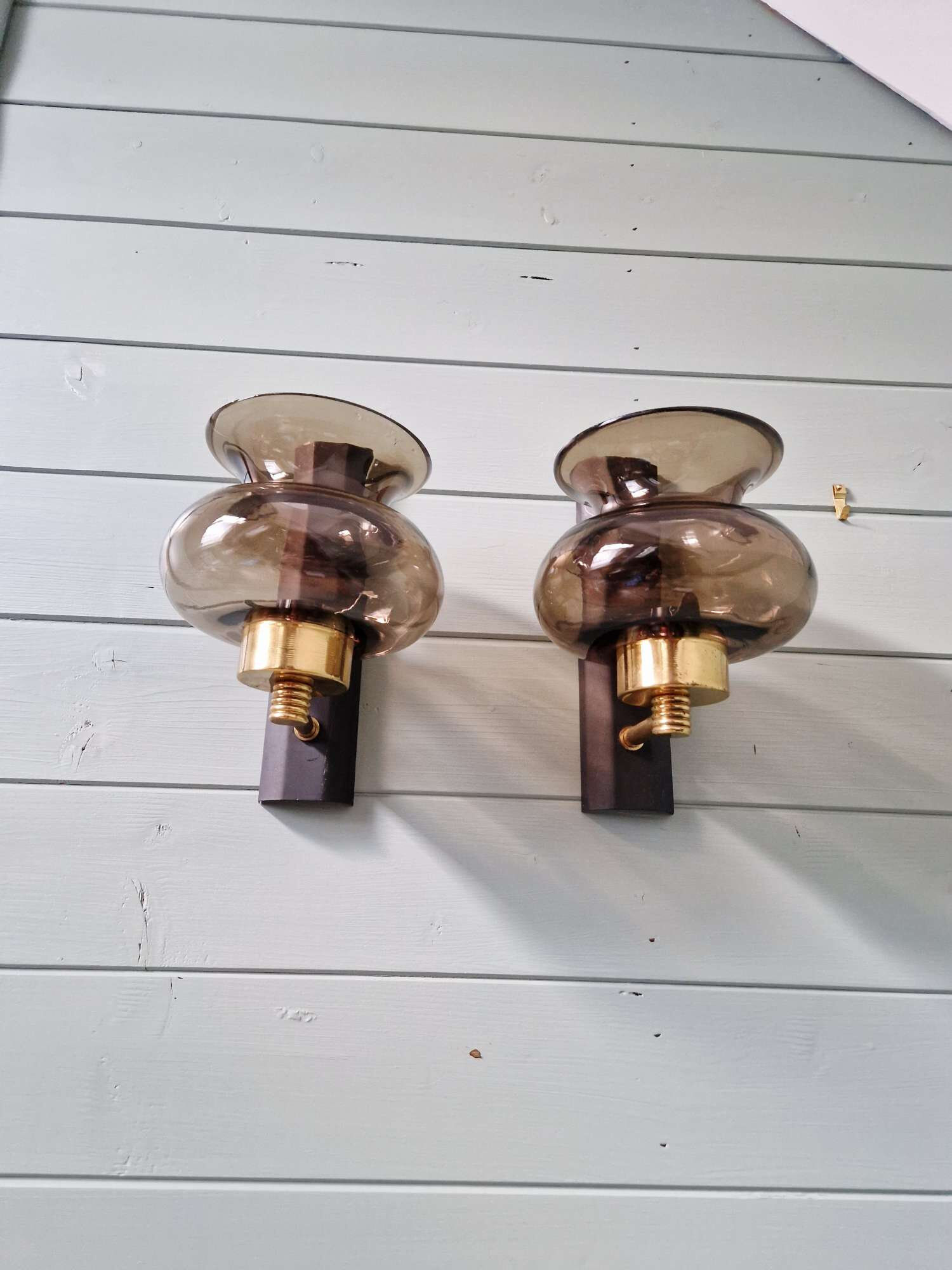 Pair of wall sconces in brass and smoked glass, 1960s.