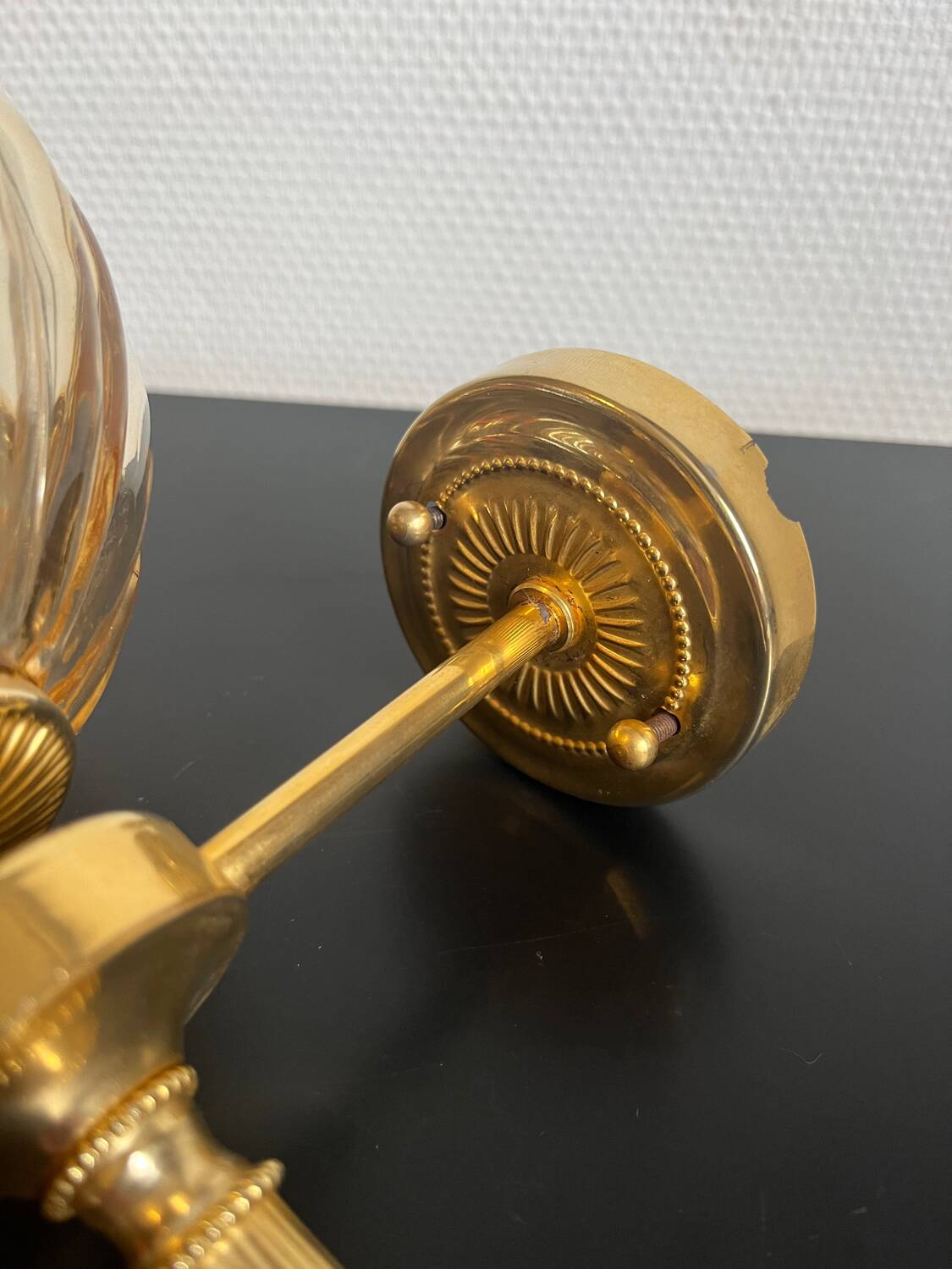 Brass wall light and bubbled glass globe