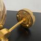 Brass wall light and bubbled glass globe