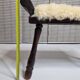 Carved wooden stool covered with Celtic-style sheepskin