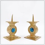 Pair of brass candlesticks decorated with a blue stone inlaid in the center