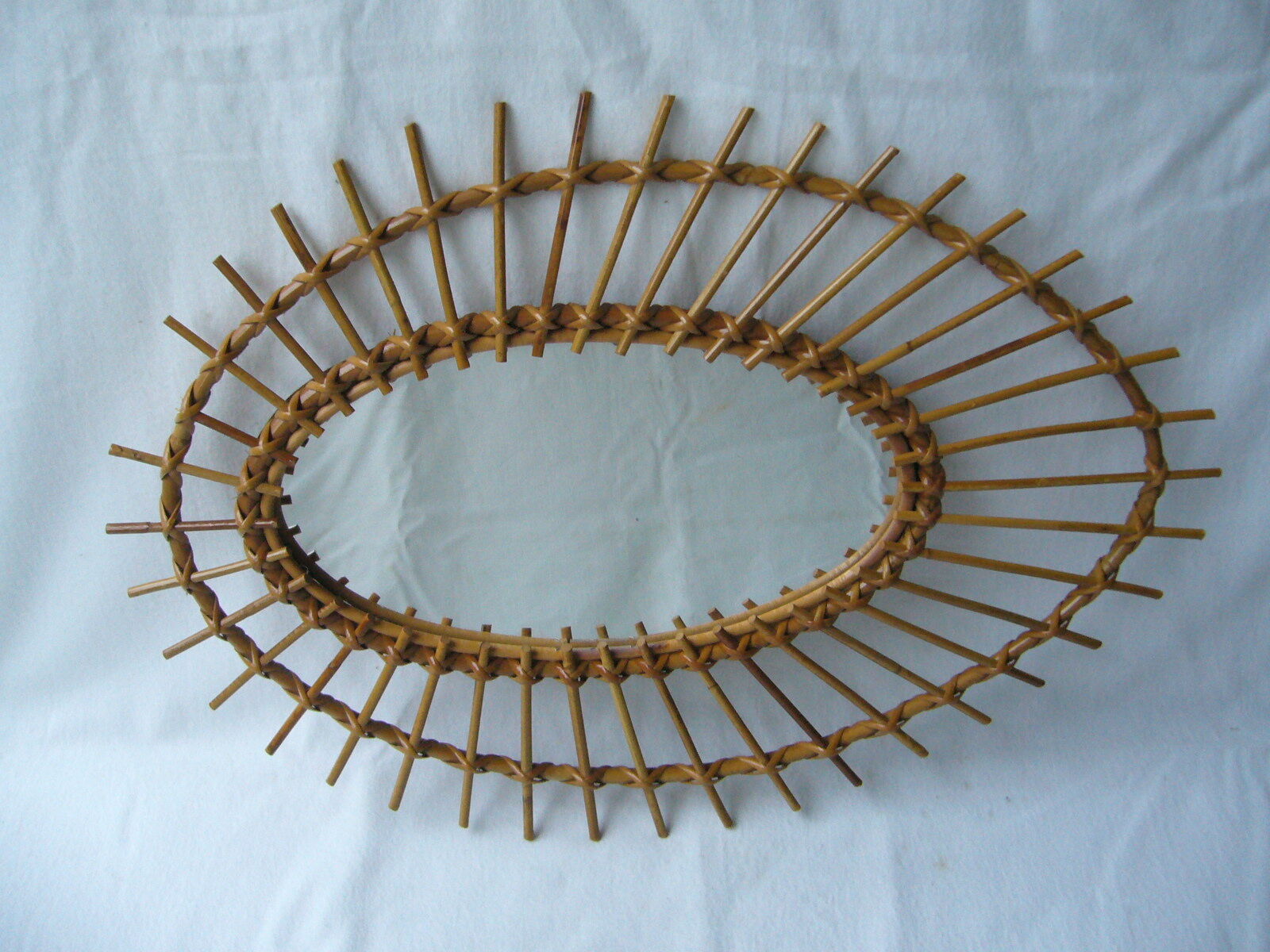 Vintage oval mirror in rattan