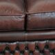 Classic cowhide Chesterfield sofa in English style with red/brown colours