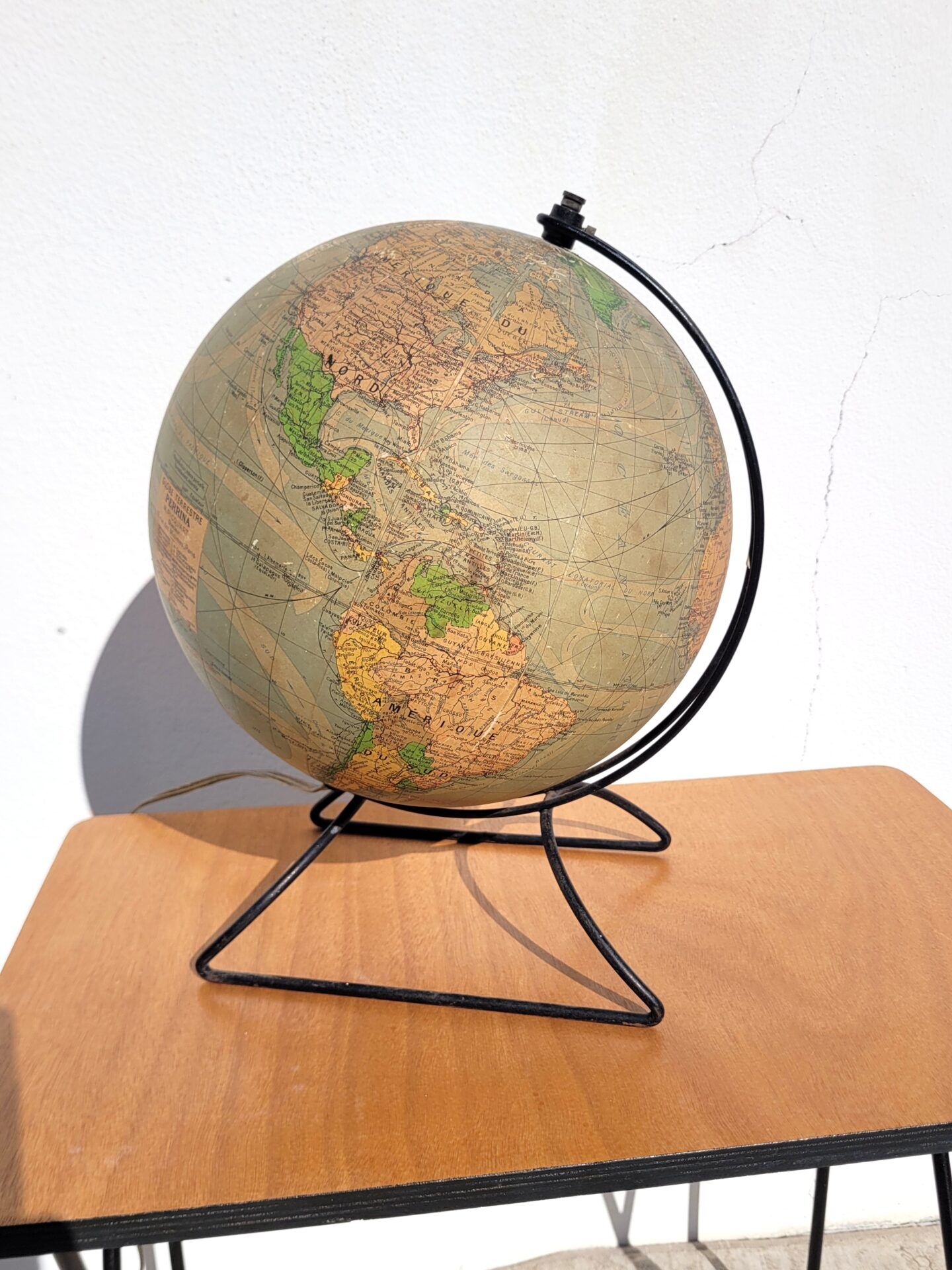 Old illuminated globe world map made of glass and paper.