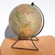 Old illuminated globe world map made of glass and paper.