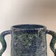 Blue-green ceramic vase with abstract wavy handles