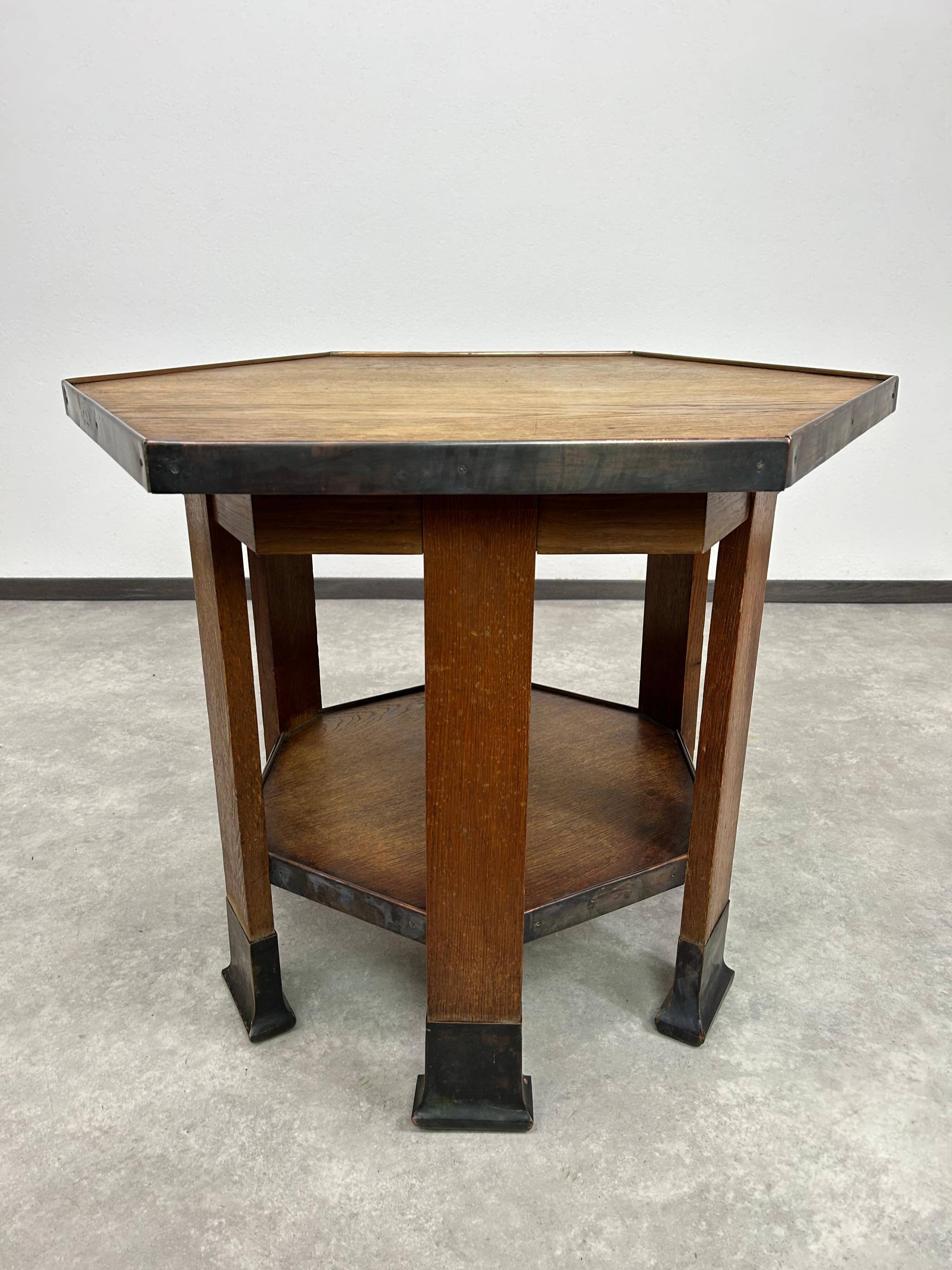 Hexagonal table with six legs in Secession style bordered with brass, attributed to Adolf Loos.