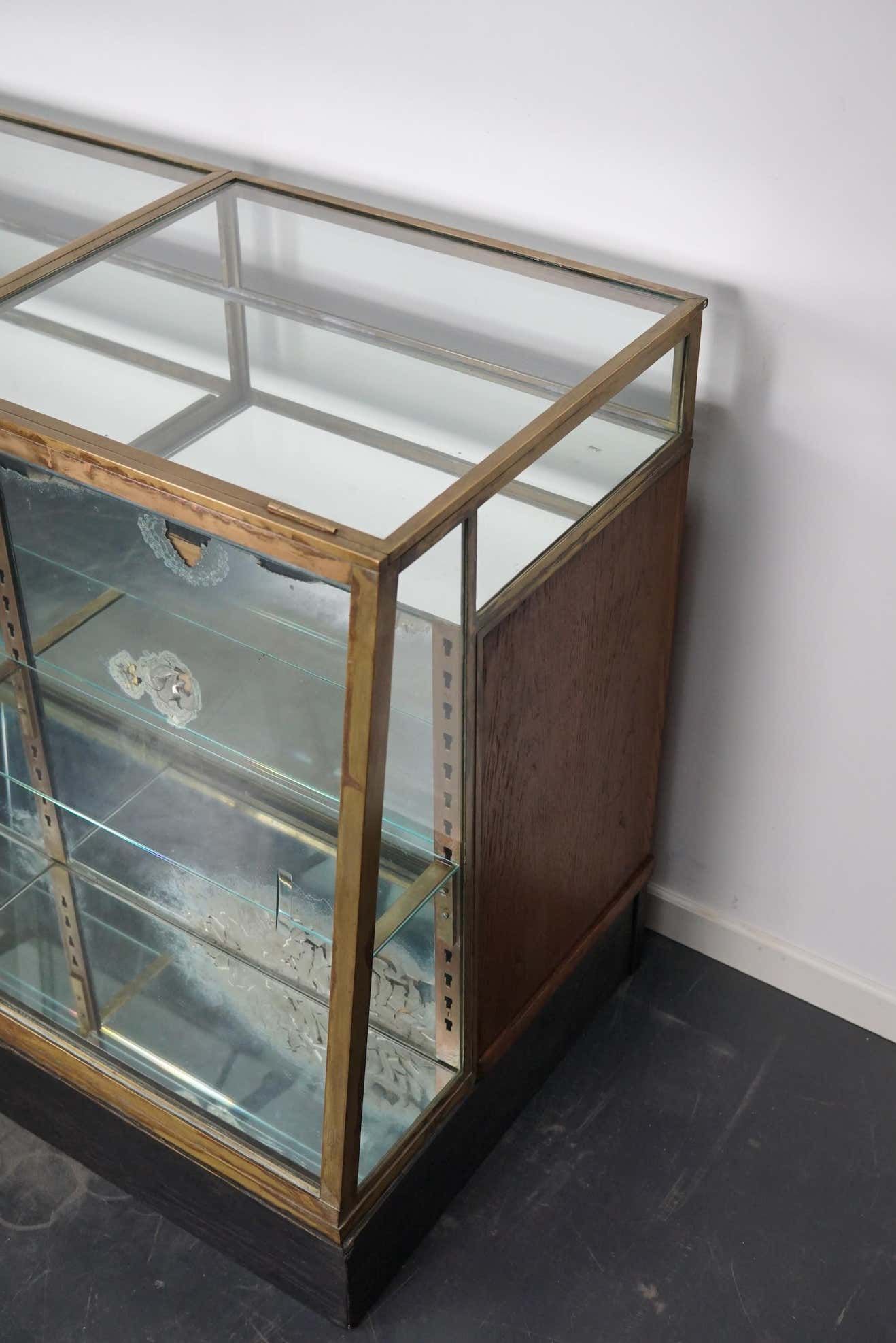 Counter or shop window in oak glass and brass France around 1920