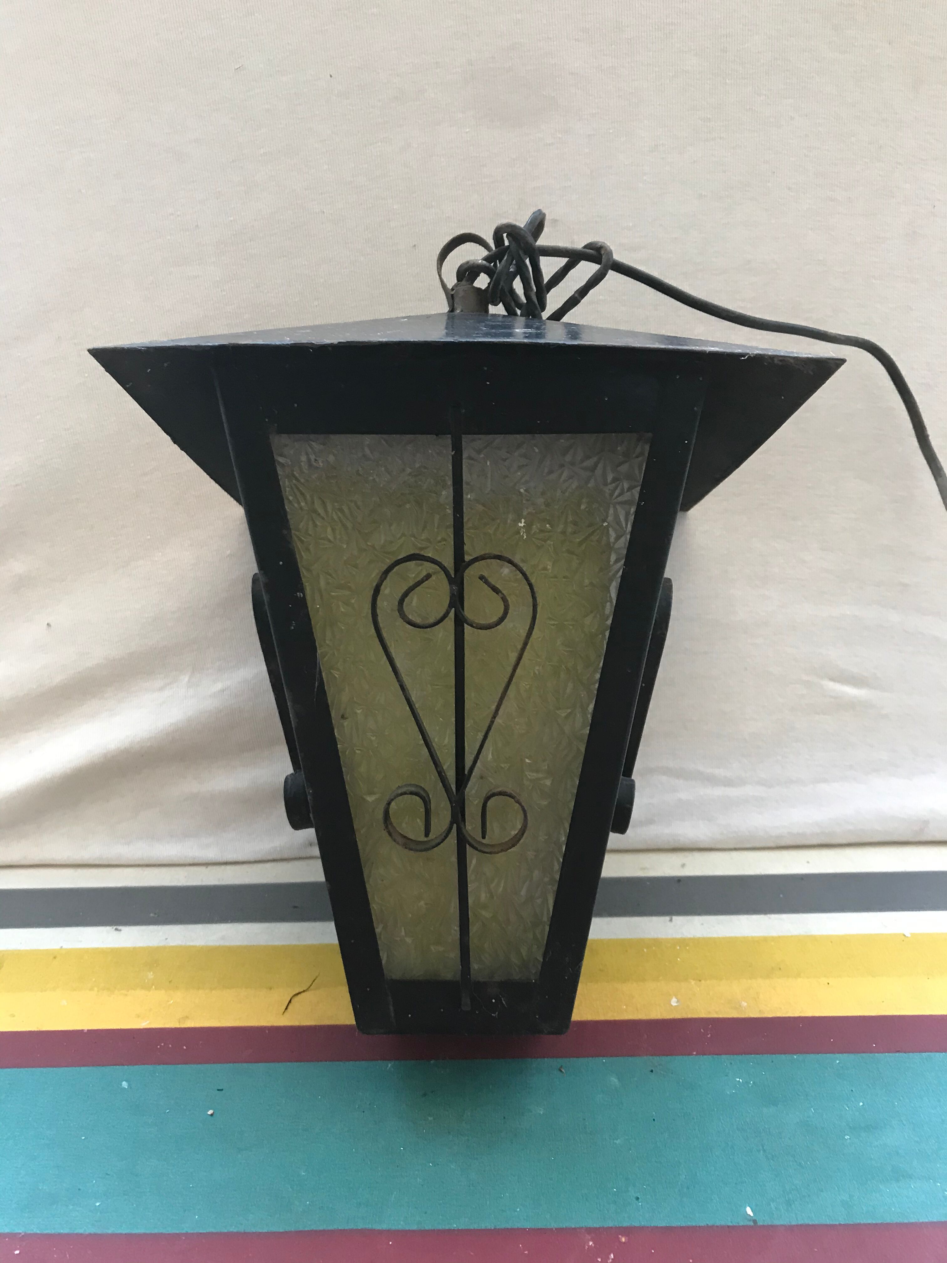 Old black forged iron suspension vintage in moulded glass