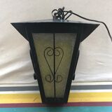 Old black forged iron suspension vintage in moulded glass