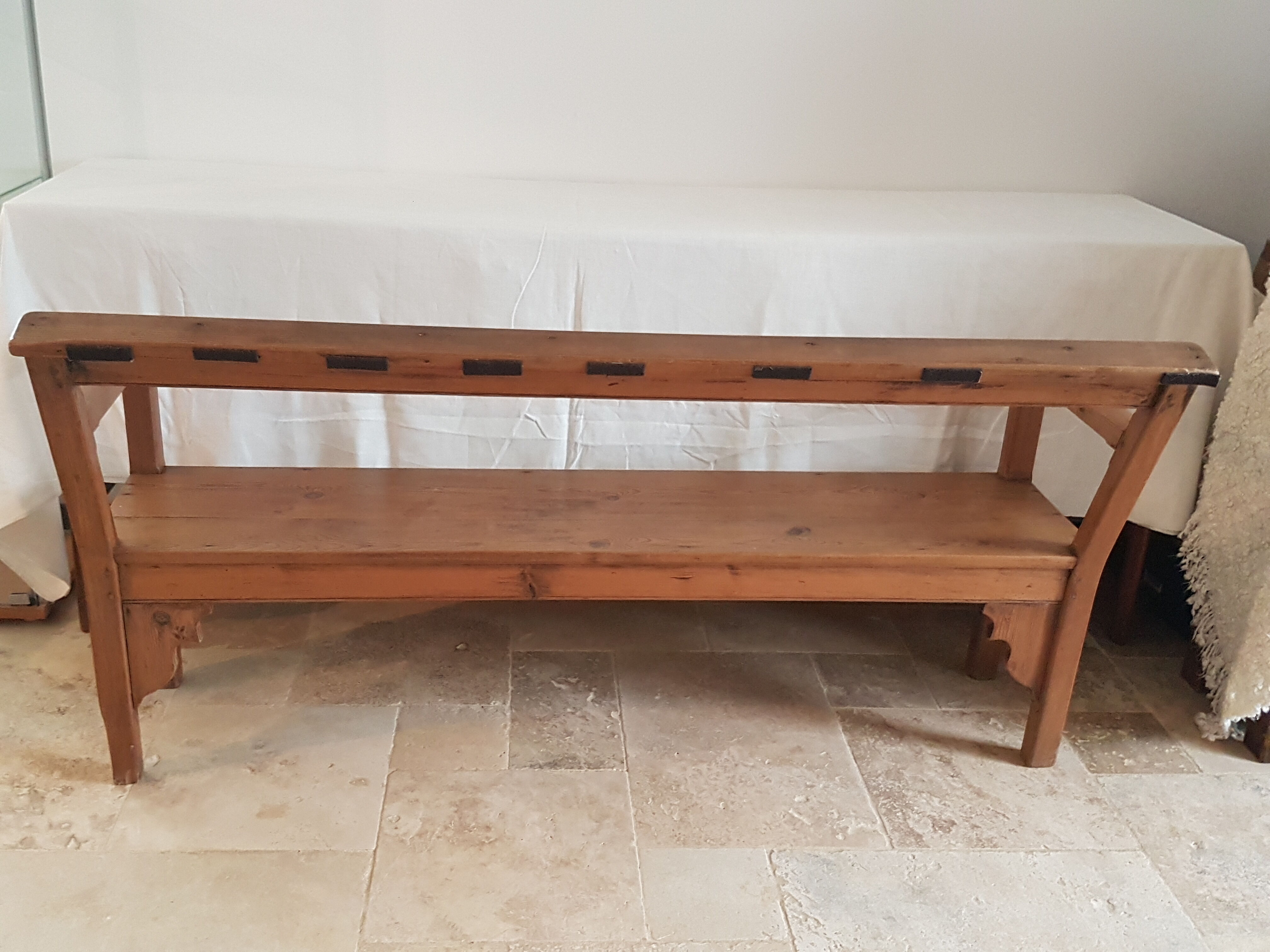 Church bench in fir tree with armrests