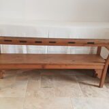 Church bench in fir tree with armrests